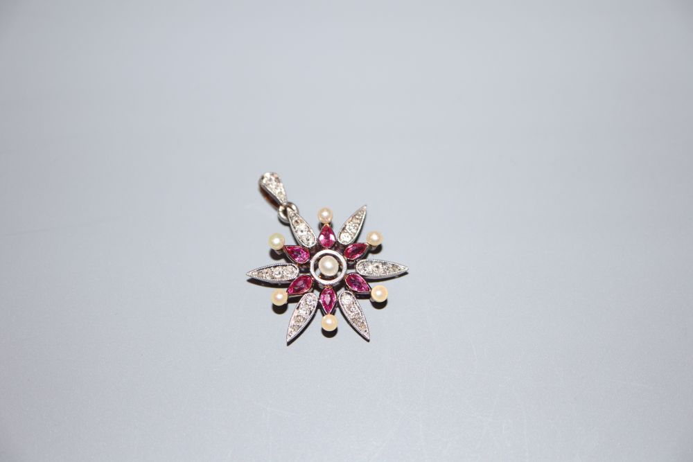 A late Victorian yellow metal, ruby, diamond and seed pearl set starburst pendant brooch, 33mm